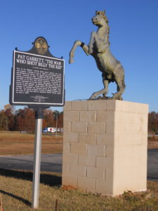 Pat Garrett Monument Cusetta, Alabama. Horse standing on concrete block.