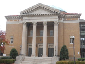 Southern Synagogues: Temple Emanu-El Birmingham Alabama. Brown tinted brick building with four two-story pillars.