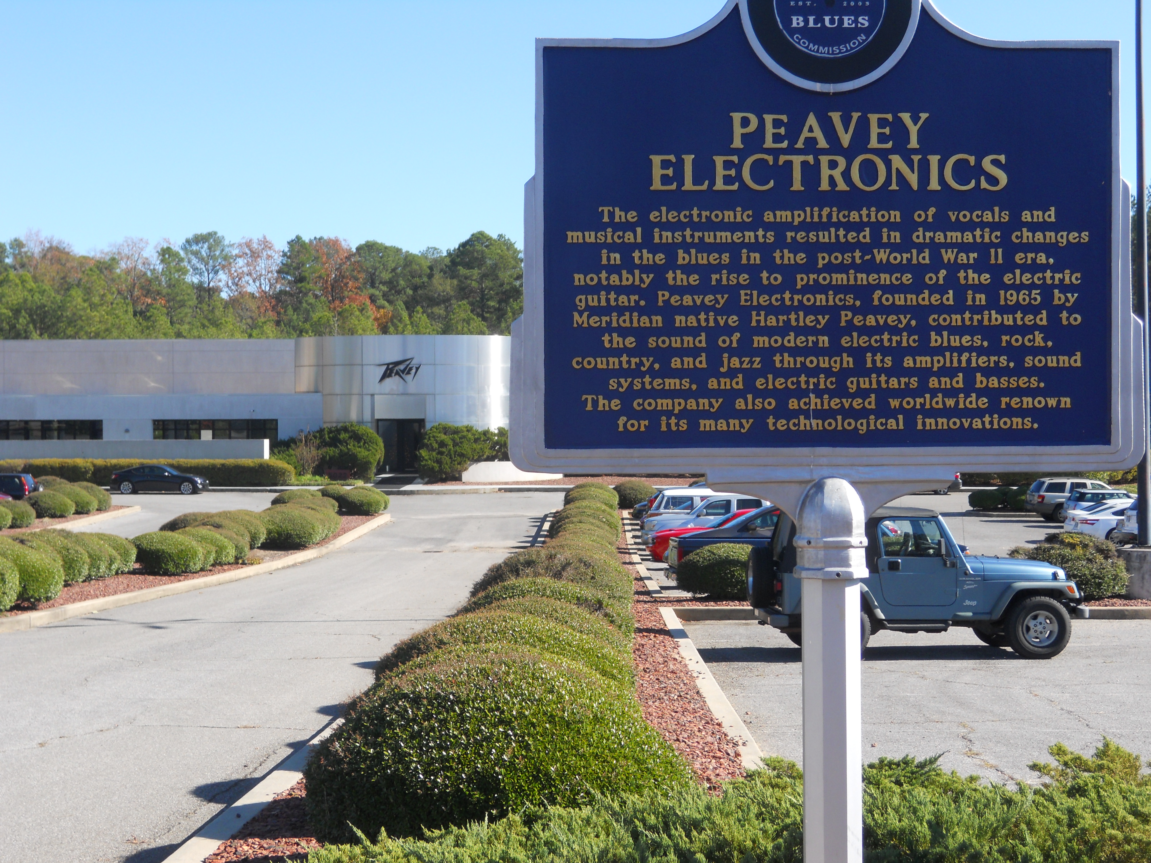 Schoolnik is on the road again, visiting Peavey Electonics in Meridian Mississippi. Metal corporate office building with historical marker in foreground.