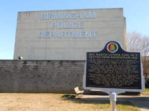 Schoolnik visiting the Birmingham Police Department building. Placard in foreground commemorating Martin Luther King's Letter from a Birmingham Jail" 