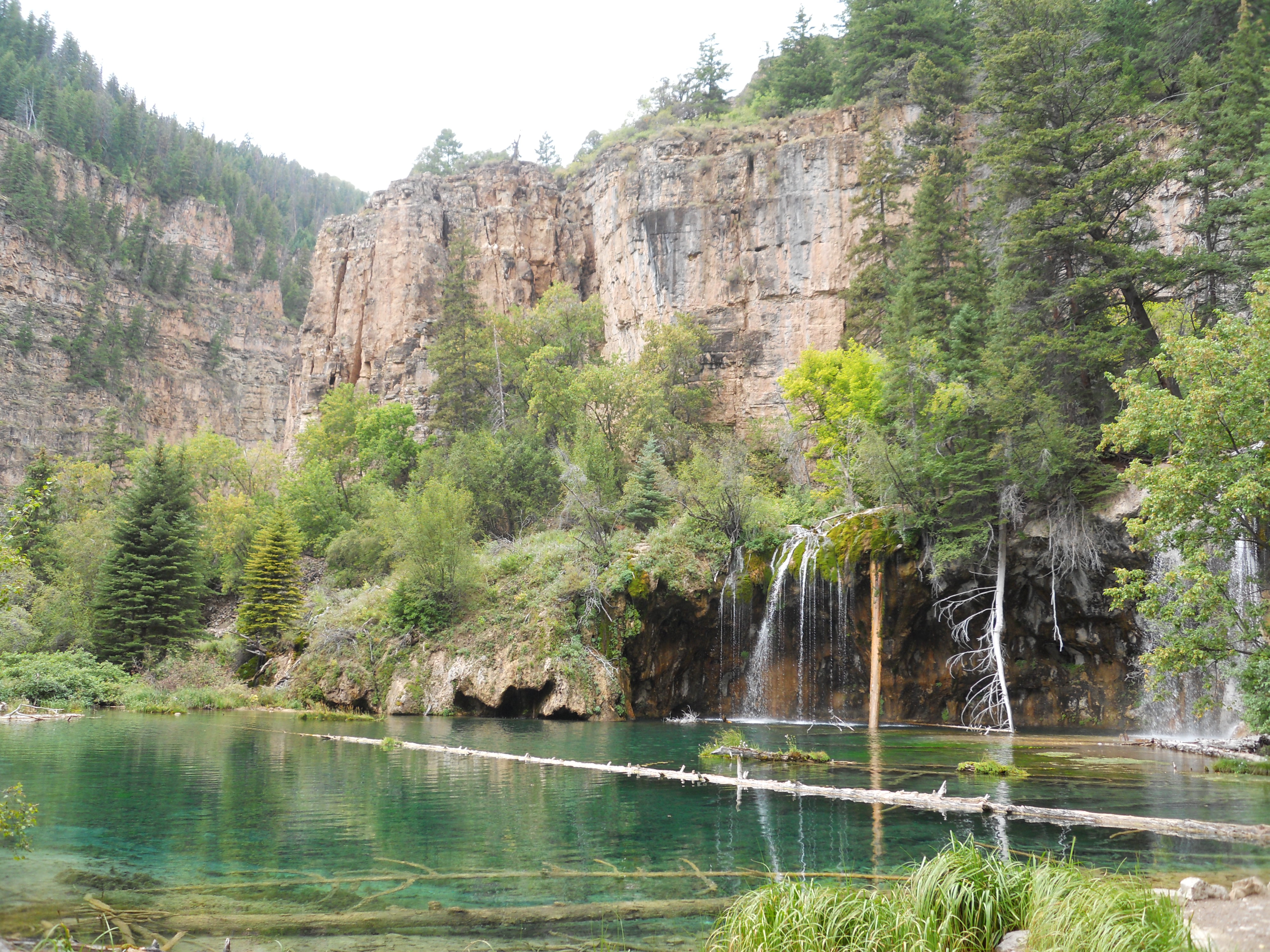 Hanging Lake Glenwood Canyon, Colorado. Blue water in lake next to mountain cliffs.